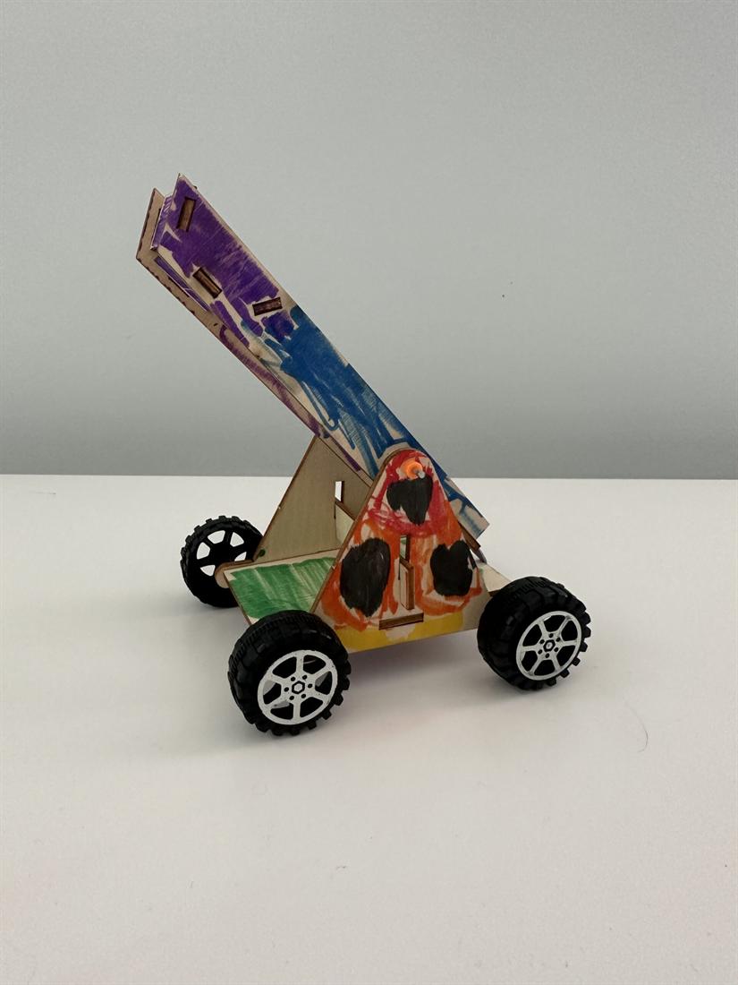 A wooden catapult car built by a camper at an Exploratores day camp